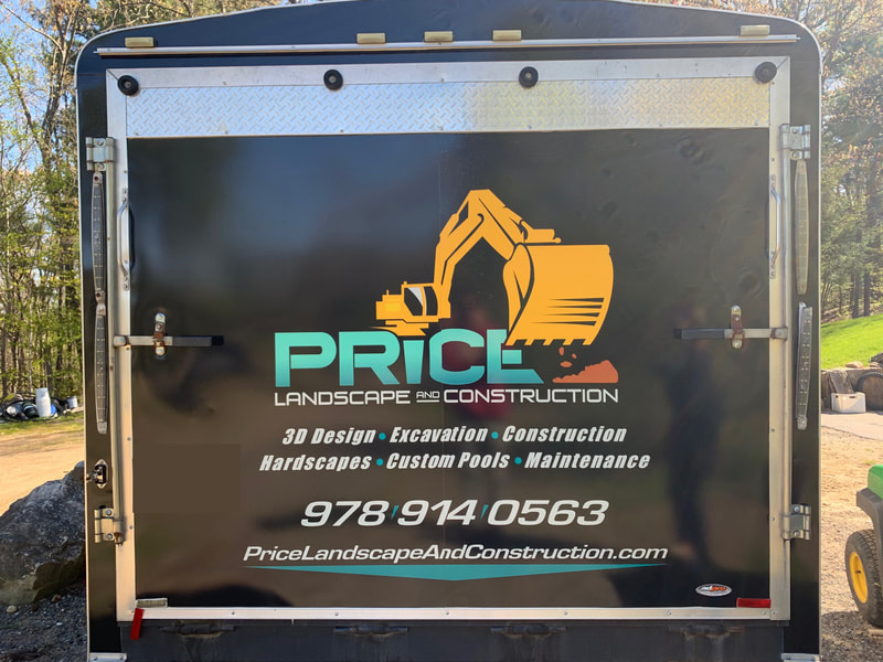 Back of landscape trailer with logo and contact information