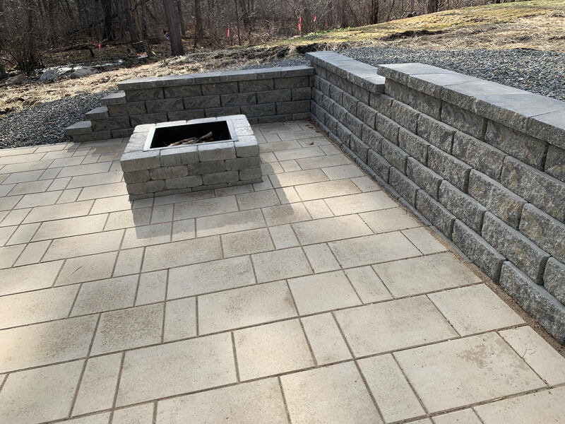 Fireplace and patio installation with stone wall